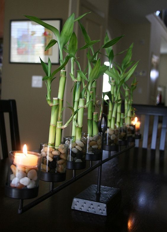 bamboo stand with rocks and a floating candle on the side