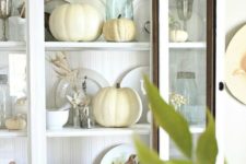 23 place neutral pumpkins and wheat into your glass kitchen cabinet