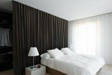 23 this heavy black curtain separates a man bedroom from an open closet