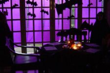 26 use purple crepe paper to cover a large window or glass door, and then cut up black bats in different sizes