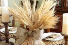 28 wheat with a burlap bow on a wooden slice is an ideal no fuss centerpiece