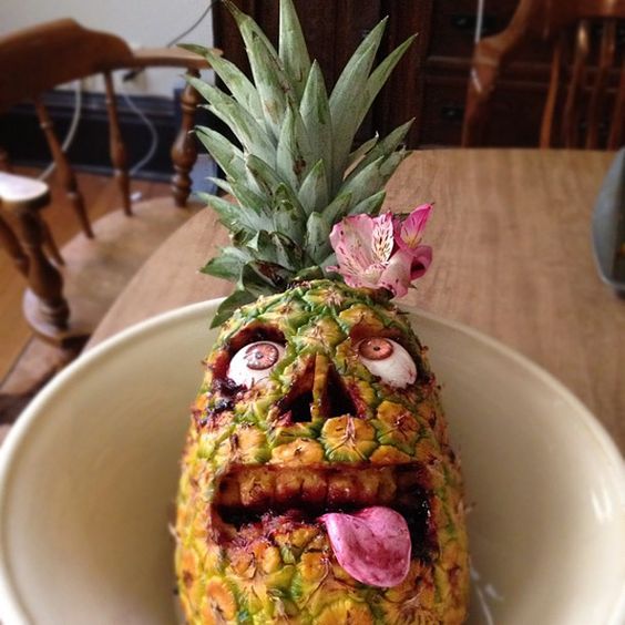 real pineapple, cherry Laffy Taffy tongue, black raspberry jam blood and custom undead eyes comprise a pineapple zombie face