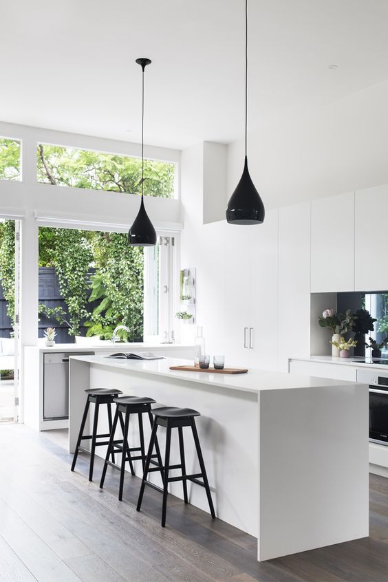 aesthetic white kitchen with several black accents looks airy and bright
