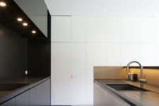 32 kitchen with a white and a black half and lights to keep the space luminous