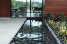 35 simple and stylish water feature mirrors the contemporary glass facade beautifully