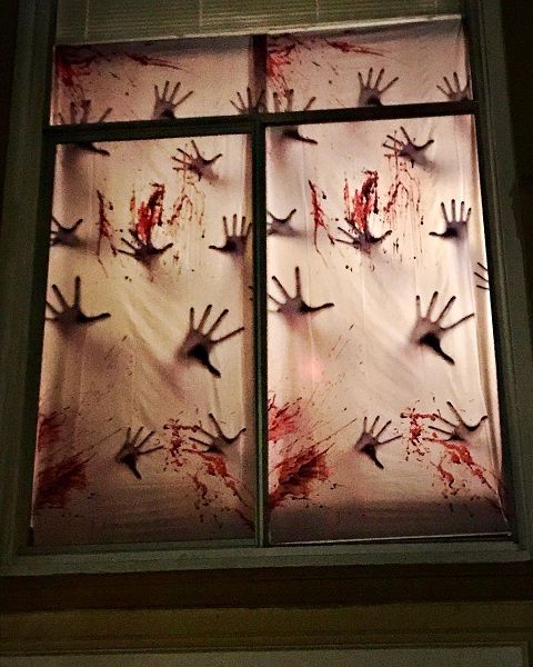 a mix of a bunch of hands and a lot of blood behind a simple white sheet looks quite impressive