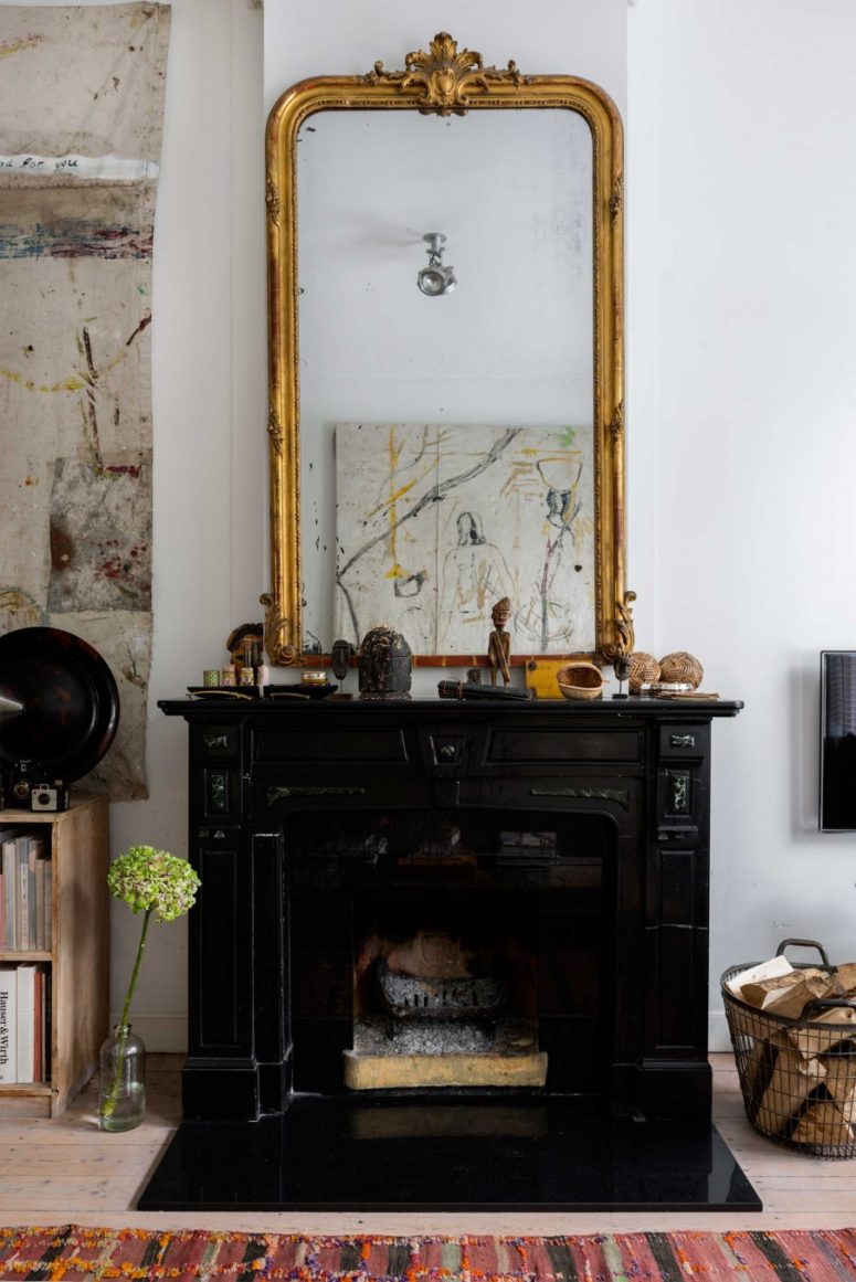 Every space in the house has a black vintage fireplace with an oversized mirror