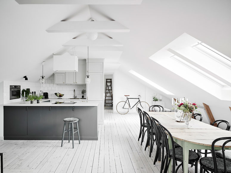 The dining space and kitchen are united in one, and while the kitchen is modern grey, the dining area is with shabby chic furniture