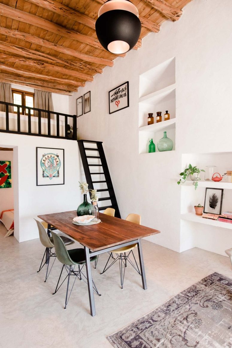 eclectic house The dining zone is a small one, and the stairs leads to a tiny bedroom, which is separated for privacy