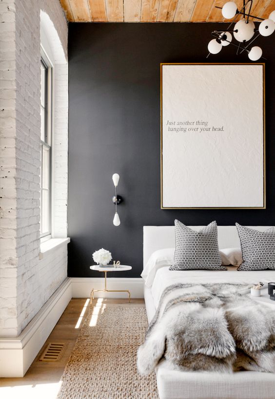 a black accent wall and white brick create a beautiful contrast