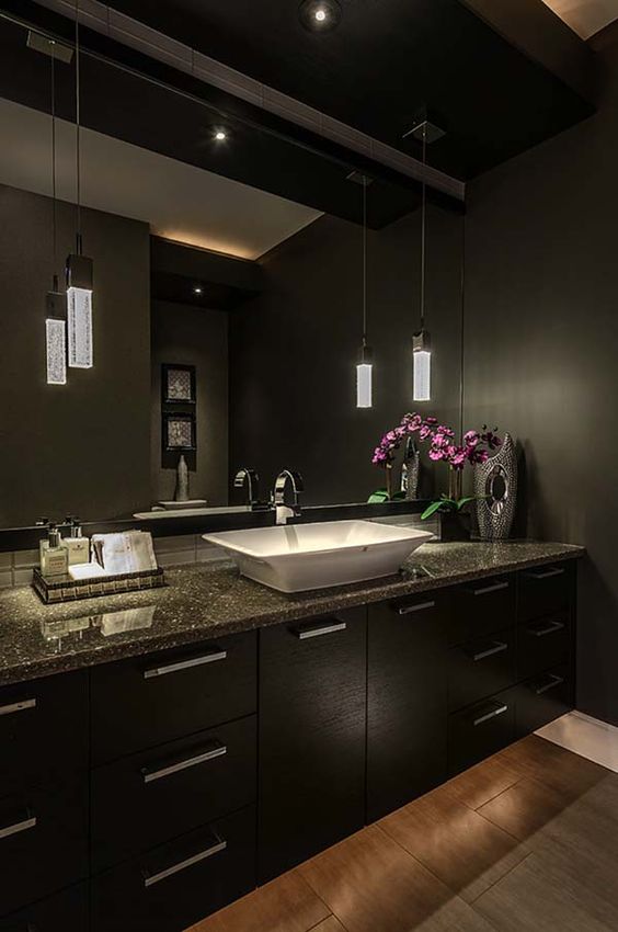 Asian inspired space with dark cabinets and walls and chic pendant lamps