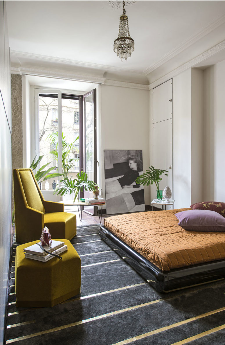 geometric decor The bedroom surprises with geometric furniture, a sleek black bed on the floor and bold textiles