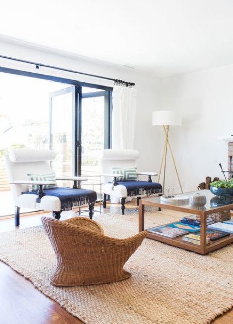 accentuate a neutral room with a jute rug and wicker furniture with navy textiles