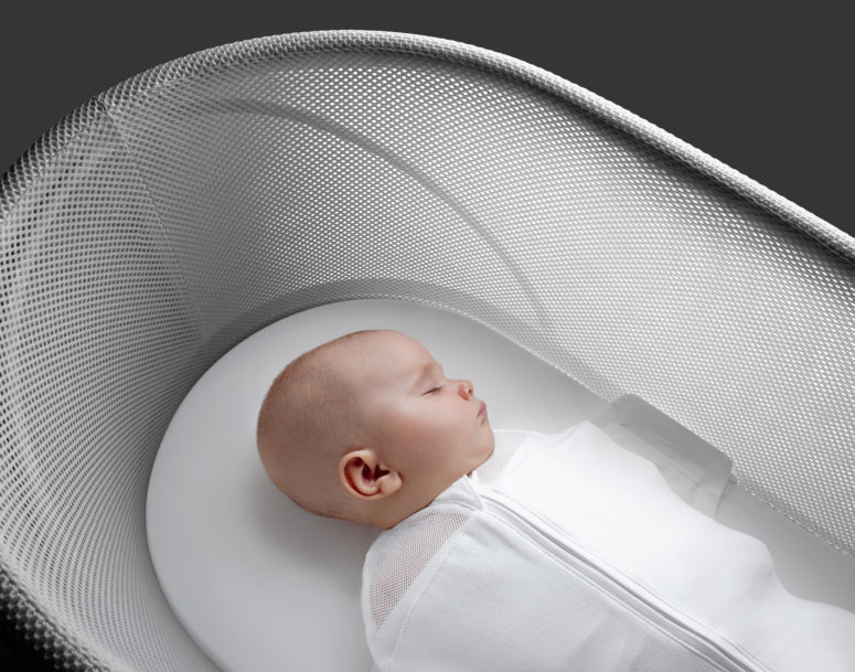 A cotton swaddle is designed to hold the baby in a sleeping position