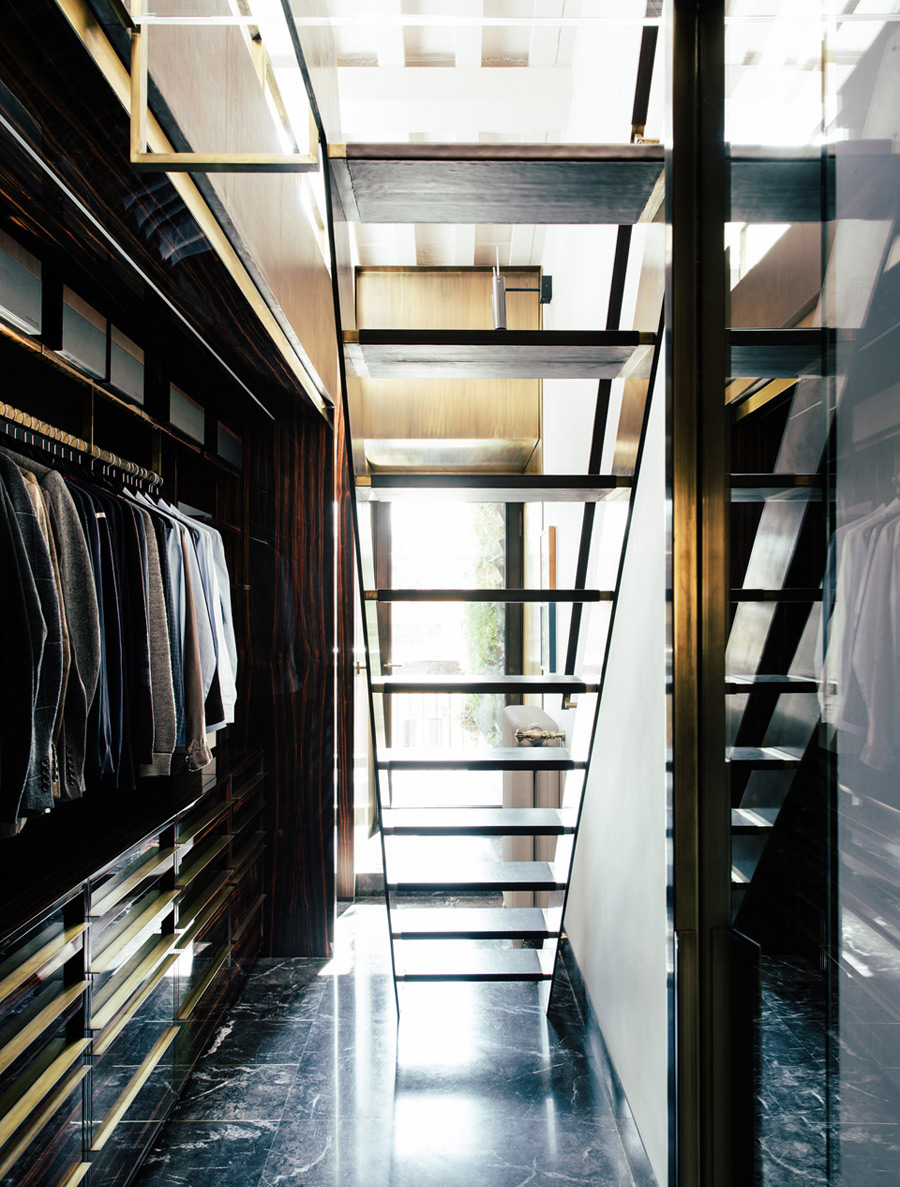 The closet is hidden downstairs, it's elegant, light filled and with bold brass accents