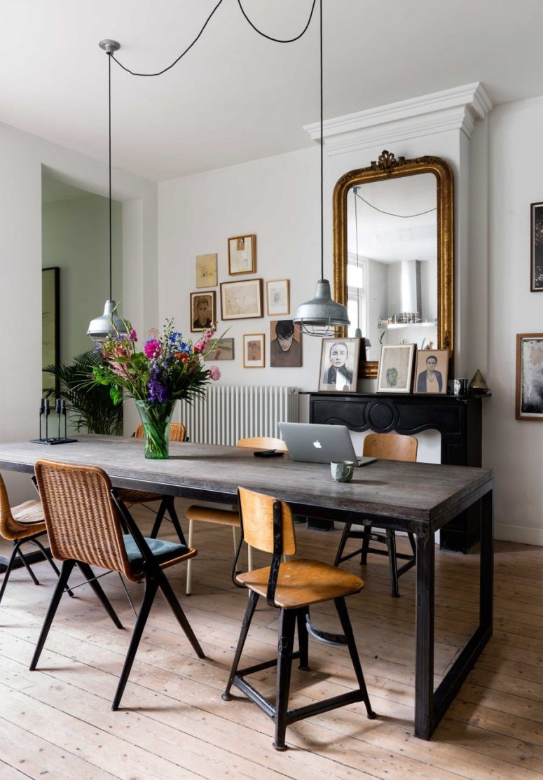 stylish dining The dining area also has a non-working fireplace, a rustic dining table, art gallery wall and industrial pendant lamps