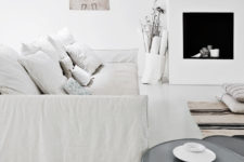 04 The living room is Scandi classics, with a faux fireplace, rough white textiles and even burlap