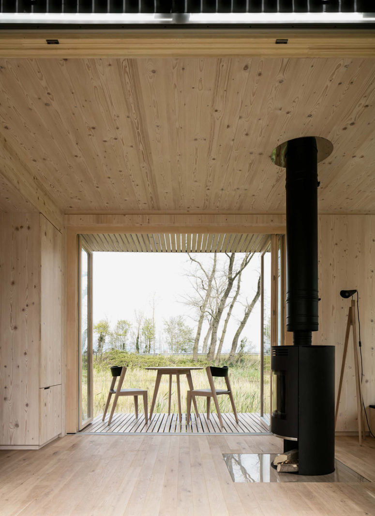 The stove separates the sleeping area from the living space, it's a way to warm up the space and to divide it The stove separates the sleeping area from the living space, it's a way to warm up the space and to divide it