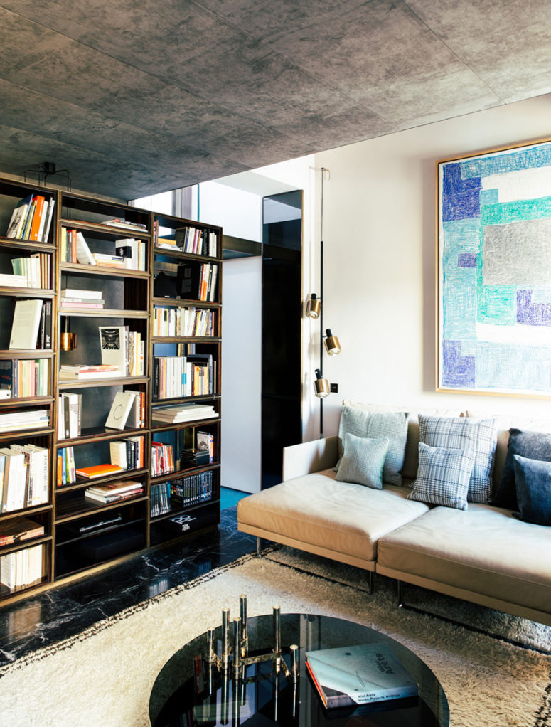 The living room is lighter and fresher, black marble on the floor, beige textiles and blue accents look chic and welcoming