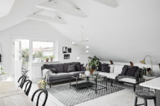 05 The living space features two sofas in grey and white, mid-century modern lamps and textiles bring coziness