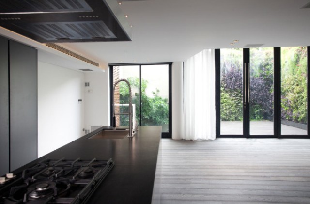 The space is filled with light as there are floor to ceiling windows and doors to the terrace