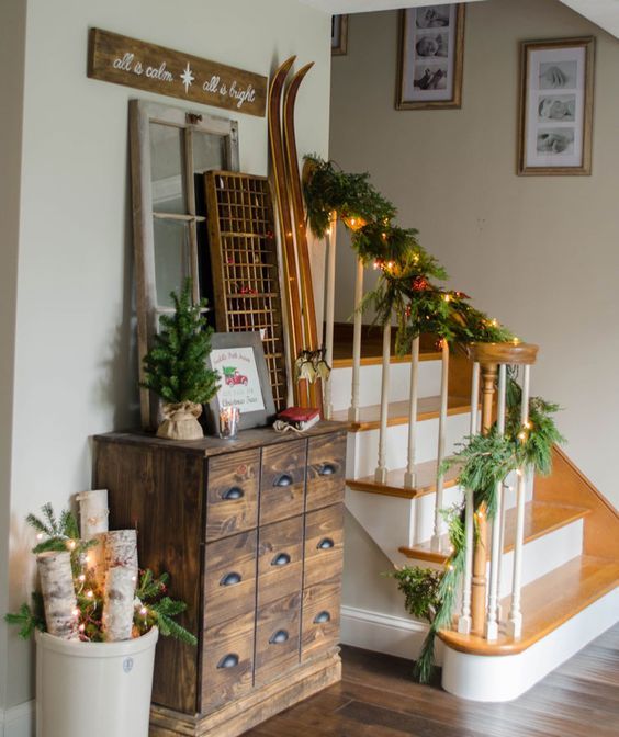 firewood in a box with lights, lit garland and a small tree in burlap