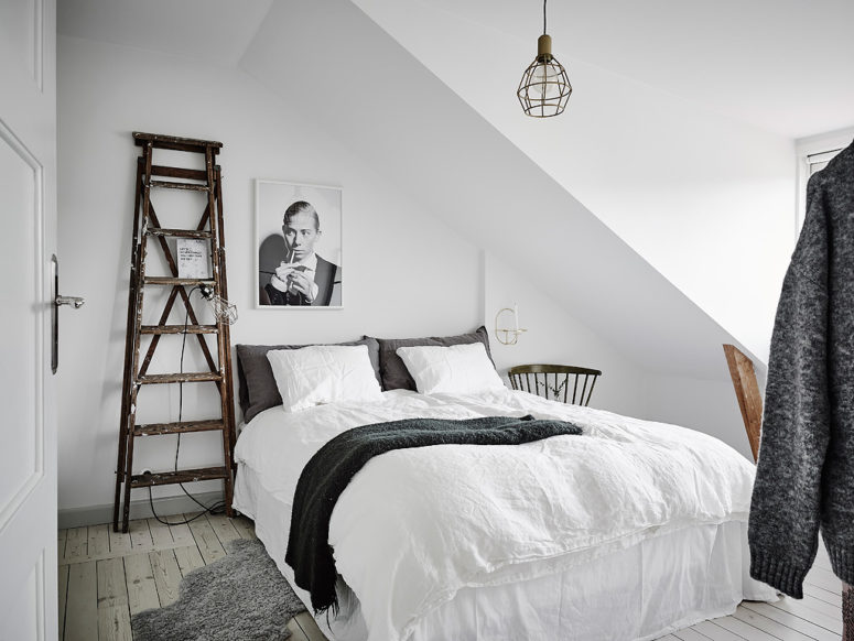 White Scandinavian Apartment With Shabby Chic Touches The bedroom is small, cozy and welcoming, in grey and white, with vintage and industrial touches