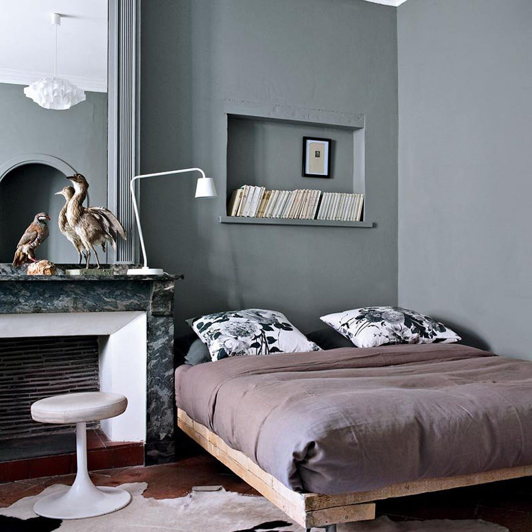 The master bedroom is done in graphite grey, there's another cool fireplace and a rough wood bed in the corner The master bedroom is done in graphite grey, there's another cool fireplace and a rough wood bed in the corner