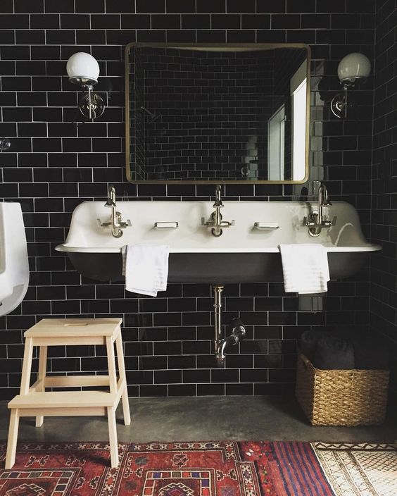 black subway tiles become a focal point and create a mood in this vintage bathroom
