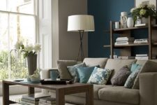 07 grey and beige room with a teal accent wall, blue pillows and accessories