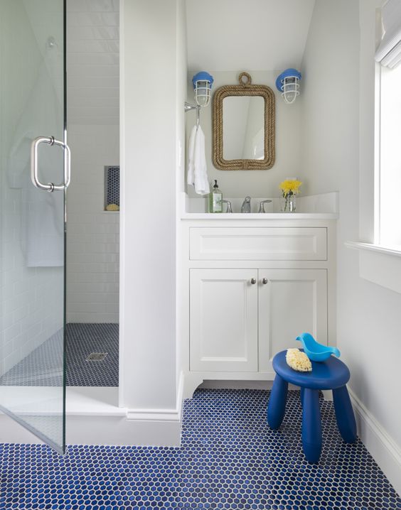 blue an dnavy penny tile floor is ideal for a nautical bathroom