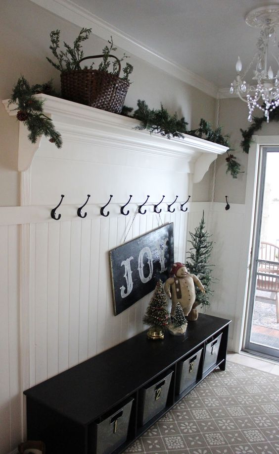 fir branch garland and a chalkboard sign, a stuffed snowman