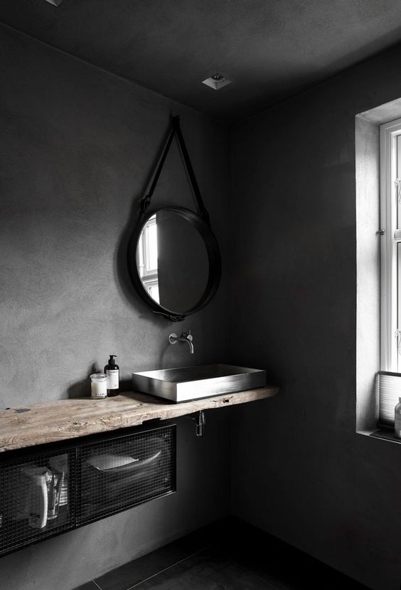 wabi-sabi space with concrete walls and a rough wood counter