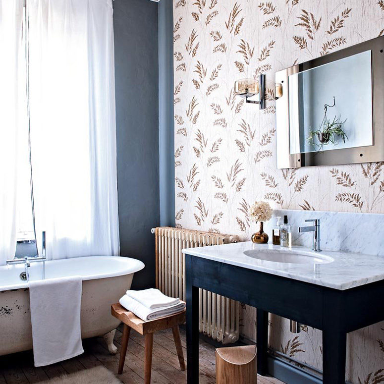 wallpaper accent wall The master bathroom has a rural print wallpaper wall, a modern mirror and faucet and lots of rustic touches