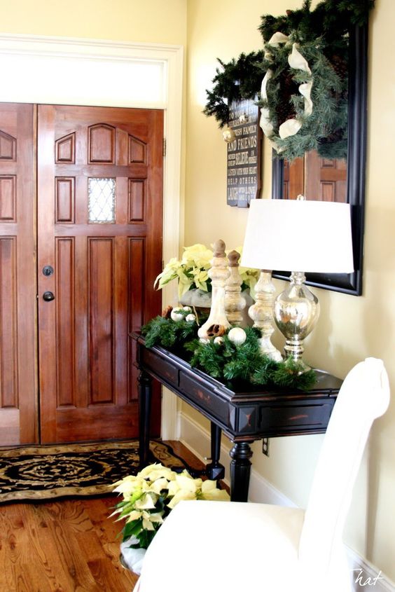 evergreen wreaths and garlands, some silver ornaments