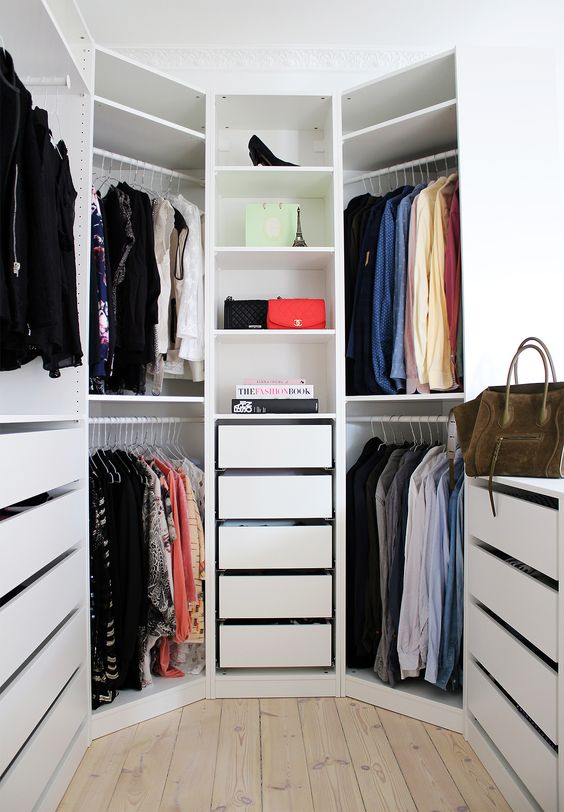 hexagon-shaped closet with drawers and open shelving, a window brings in much light