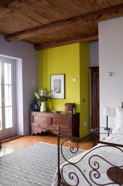 neon yellow accent wall looks fantastic in a vintage and rustic style bedroom