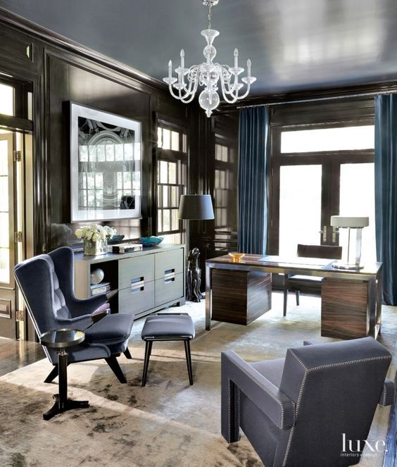 pairing chocolate paneling and cabinetry with lacquered blue shelving and a reflective blue ceiling