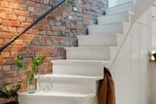 11 exposed brick wall above the stairs gives a style to this entryway