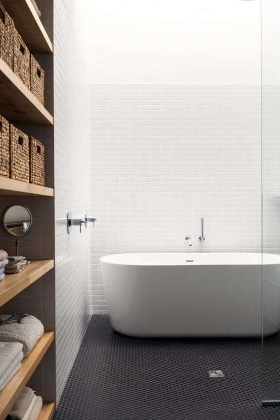 black penny tile floor makes a statement in this modern and light bathroom