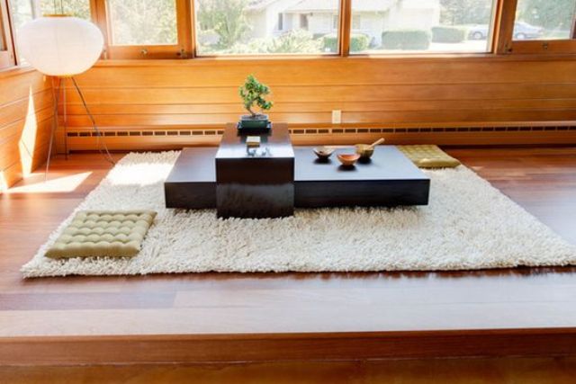 minimalist floor table in matte black and a floor carpet