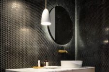 16 as black tiles are rather dark, hidden lights make the bathroom more welcoming