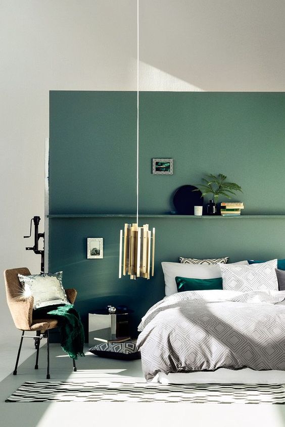 green accent wall echoes with accessories of emerald color