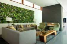 17 grey living room is spruced up with green chair and a striking wall mural