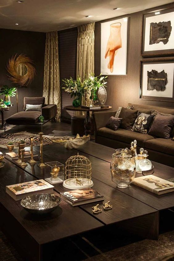 dark chocolate living room with metallic accents and greenery