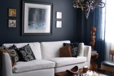 20 masculine space with a dark navy accent wall, tan chairs, warm wood furniture and accessories