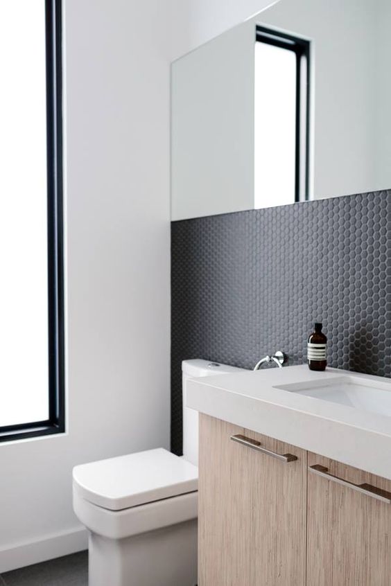 matte black penny tiles on the bathroom walls