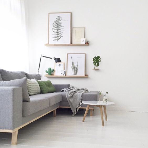 light grey sofa with green touches and botanical decorations