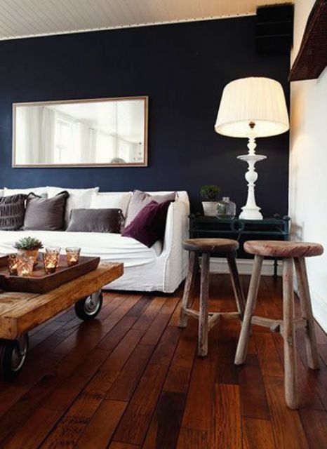 tan wood on the floor and furniture, a navy accent wall