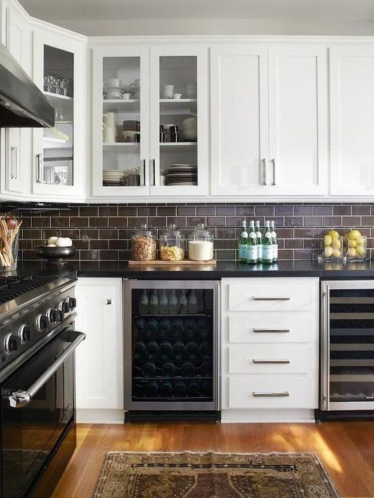 chocolate brown subway tiles look chic with black stone countertops and white cabinetry